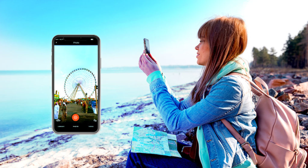 Girl taking images of her travel experience on the travall app