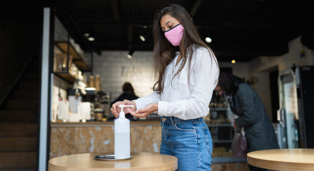 a girl using sanitizer