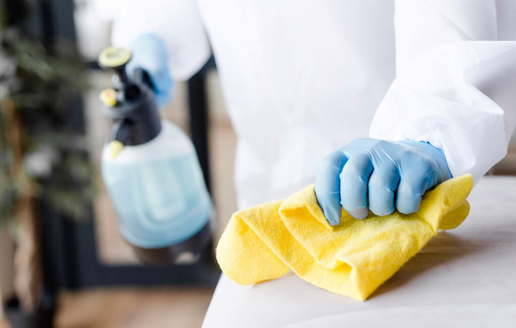 close up hand disinfecting couch